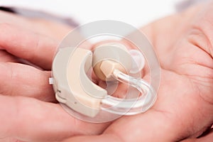 Person holding hearing aid