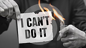 Person Holding Lighter Burning Sign Saying I Cant Do It, Overcoming Self Doubt photo