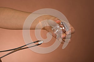 Person holding lit camphor and cup