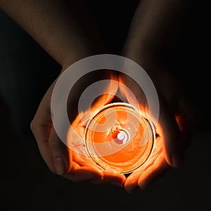 Person Holding a Lit Candle in Their Hands