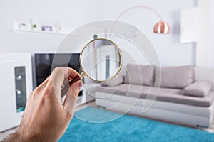 Person Holding Magnifying Glass