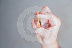 A person holding a medicine pill