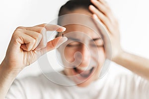 Person holding micro chip for implant with defocused screaming face. Chipization