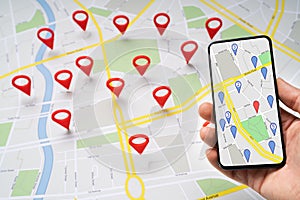 Person Holding Mobile Phone Against Map With Navigation Icons photo