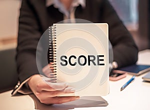 Person Holding Notebook With Score Written