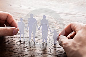 Person Holding Paper Cut Of Family