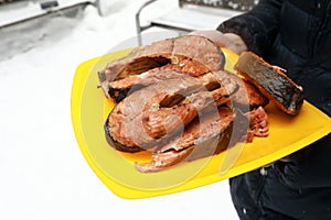 Person holding plate with grilled Coho Salmon Fillets