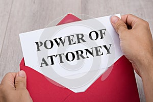 Person Holding Power Of Attorney Document In Envelope