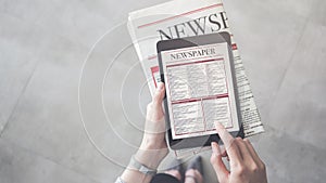 Person holding and reading news from tablet