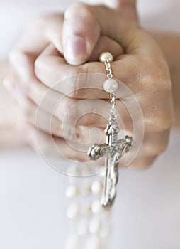 Person holding rosary beads photo