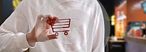 person holding a shopping cart icon, concept of online shopping market, sale and purchase