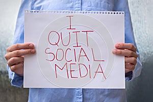 Person holding sign saying I Quit Social Media
