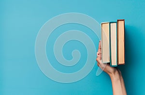 Person Holding a Stack of Books