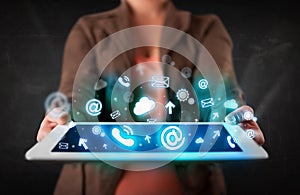 Person holding a tablet with blue technology icons and symbols