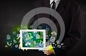 Person holding tablet with green media icons and symbols