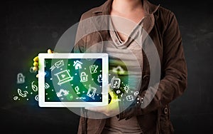 Person holding tablet with green media icons and symbols