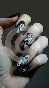 A person holding up black and white nail art