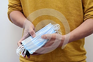 Person holding a wallet filled with face masks