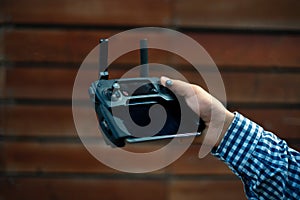 person holding a wireless gadget remote control with joystick and antenna