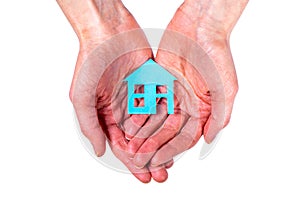 Person holds blue house with both hands isolated on white background