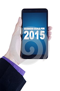 Person holds cellphone with business goals for 2015