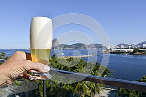 Person holds a glass of beer photo