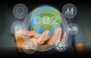A person holds a globe as a comparison in terms of carbon footprint in examining the impact in world.carbon Emissions,