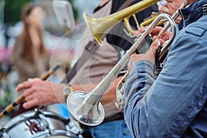 The person holds a music pipe and plays outside