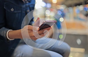 Person holds smartphone in his hands and moves his finger across screen