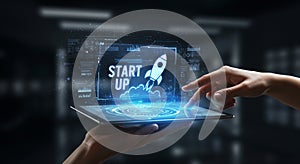 A person holds a tablet displaying digital graphics with a futuristic interface.