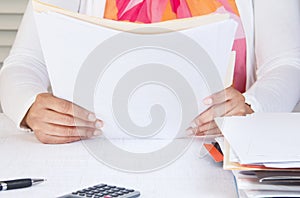 Person in home office reading documents