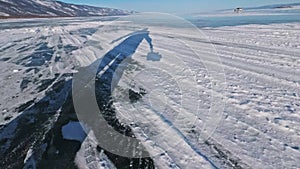 Person is ice skating at day. Pov. Man to ride hockey ice skates in nature. Outdoor winter fun for athlete nice winter