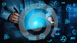 A person using a tablet device with digital futuristic interface elements, showcasing technology and data analysis in a