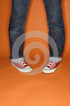 Person in jeans and sneakers