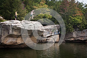 Person Jumping from Cliff into Lake