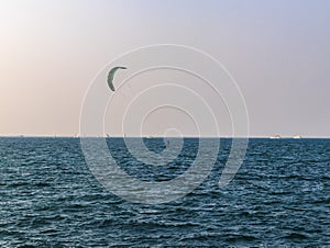 Person kite surfing in open sea. Sports