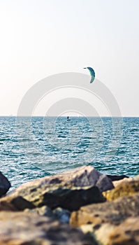 Person kite surfing in open sea. Sports