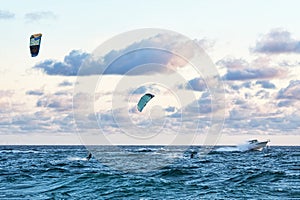 Person kitesurfing at dawn