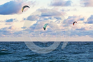 Person kitesurfing at dawn