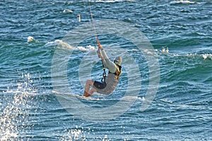 Person kitesurfing at dawn