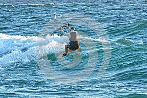 Person kitesurfing at dawn