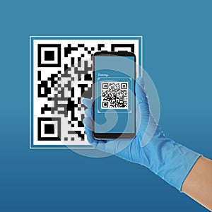 Person in latex gloves scanning QR code with smartphone on blue background, closeup