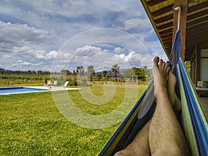 Person on paraguayan hammock at countryside landscape photo