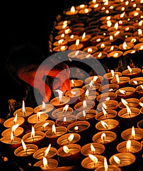 Person lights a candle during the ceremony
