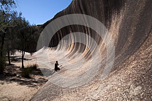 Person looking back along the natural feature called wave rock