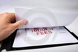 Person Looking At Hidden Fees In Contract