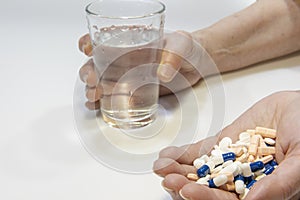 A person with a lot of medication tablets in hand