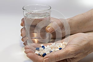 A person with a lot of medication tablets in hand