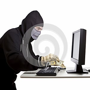 Person in mask and gloves with money at computer, suggesting cybercrime