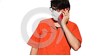 Person with mask and orange shirt while telephoning on white bac